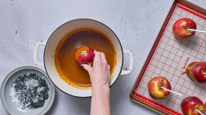 dipping apples into caramel