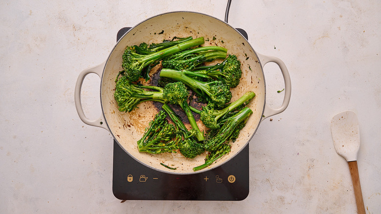 cooking broccolini in skillet