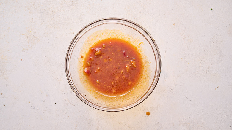 whisking noodle sauce in bowl