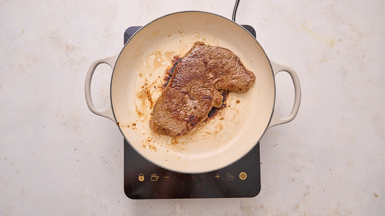 searing steak in skillet