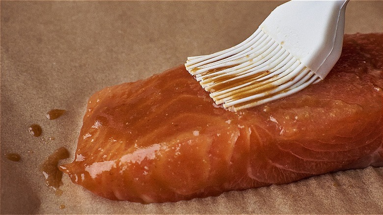 brushing glaze on salmon