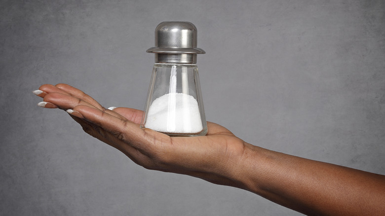 woman holding salt shaker