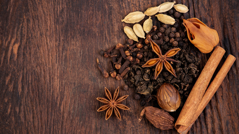 chai spices on wooden board