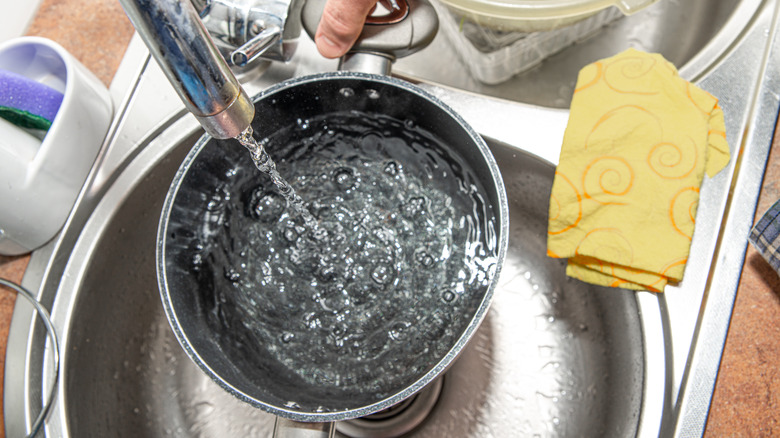 pouring water into cooking pot