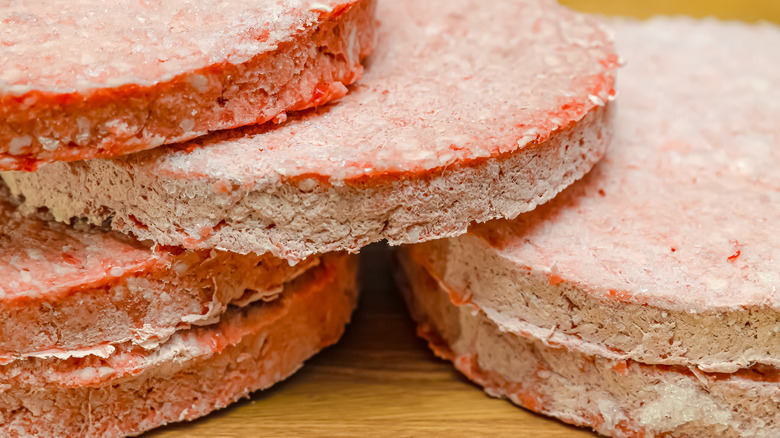 Frozen meat patties on counter