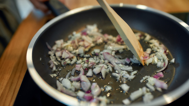 Onions and garlic sauteing in pan