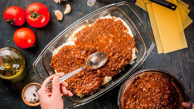 Layering lasagna sauce in dish