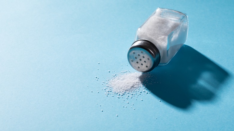 Salt shaker on blue background