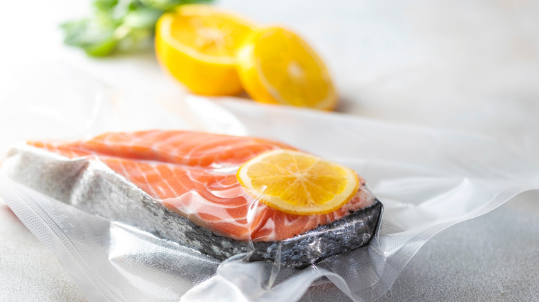 sealed fish in plastic with lemon