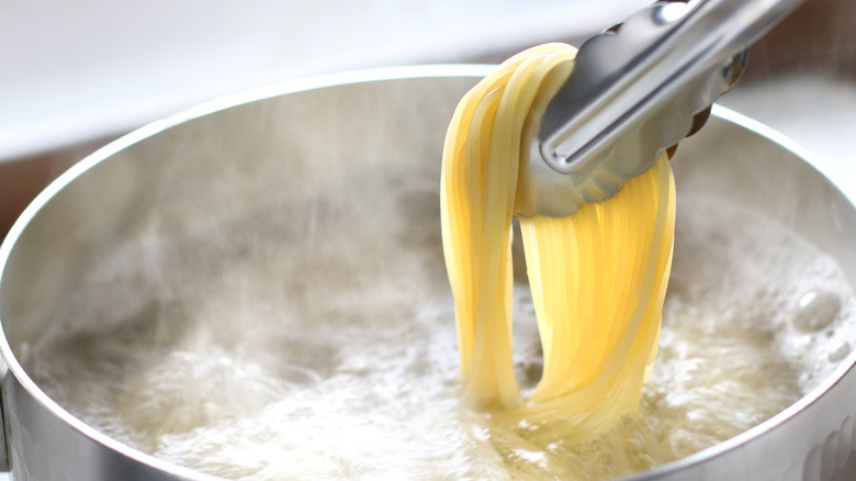 spaghetti tongs boiling water