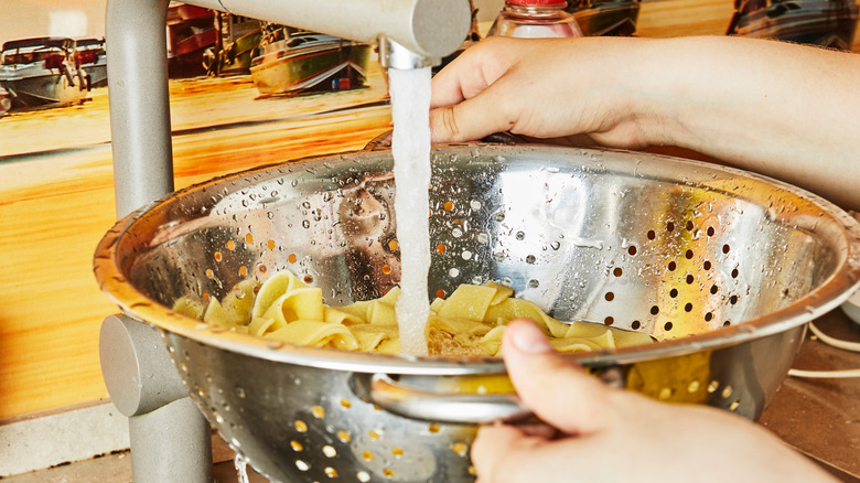 rinsing spaghetti in colander