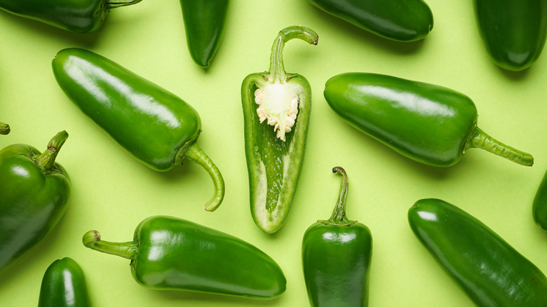 jalapeño peppers against a light green background