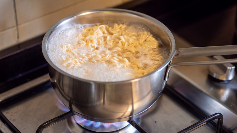 ramen noodles cooking in a pot