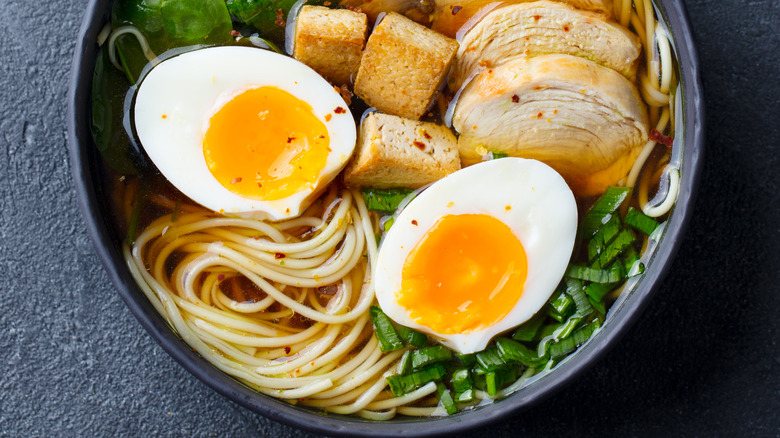 egg halves in a bowl by ramen noodles