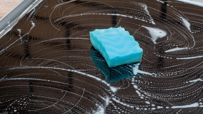 soapy stovetop with sponge