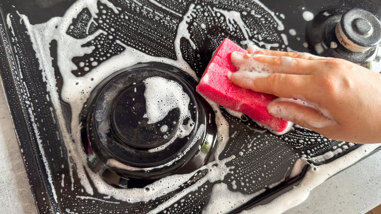 hand cleaning stove with sponge and suds