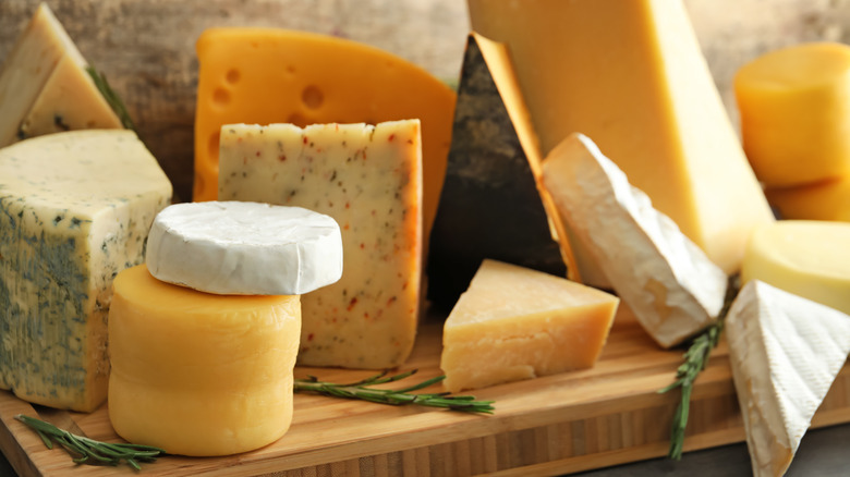 types of cheeses on wooden board