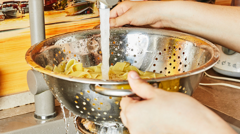 rinsing cooked pasta in water