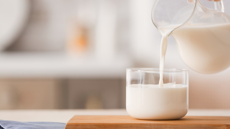 pouring whole milk into glass