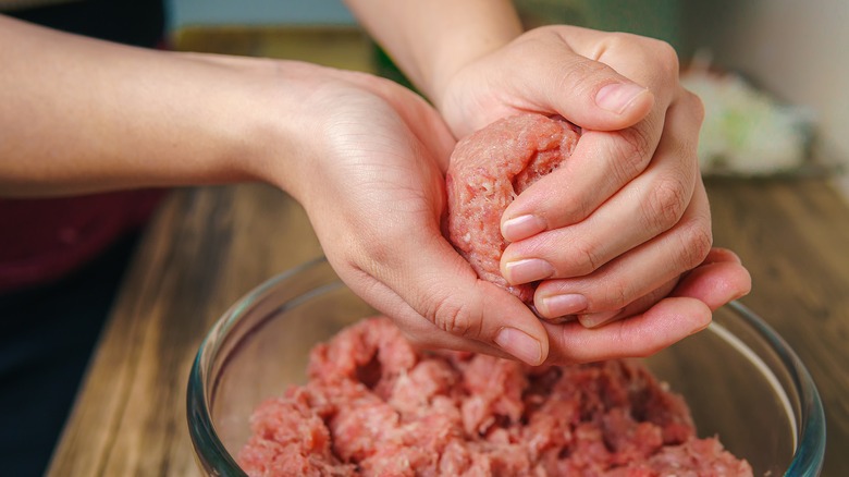 Person mixing ground beef