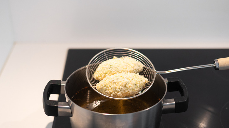 Breaded croquettes above oil 