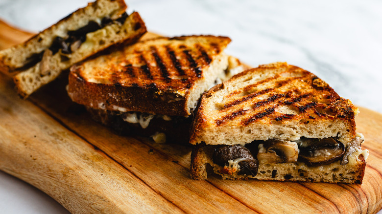 Three sandwich halves on cutting board