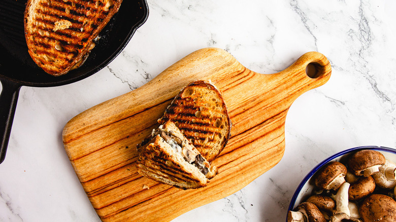 Sandwich cut in half on cutting board