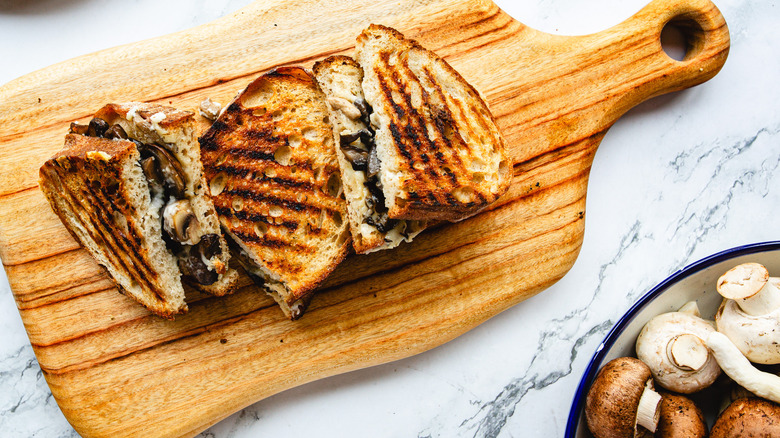 Three sandwich halves on cutting board