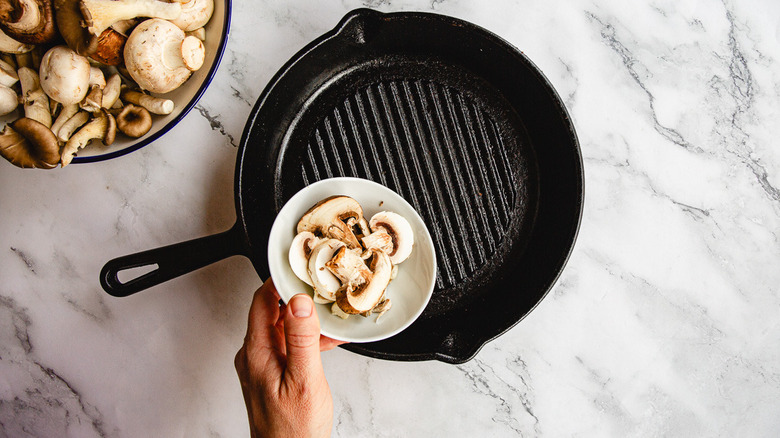 Adding mushrooms to pan