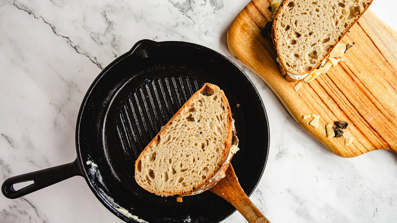 Adding sandwiches to pan