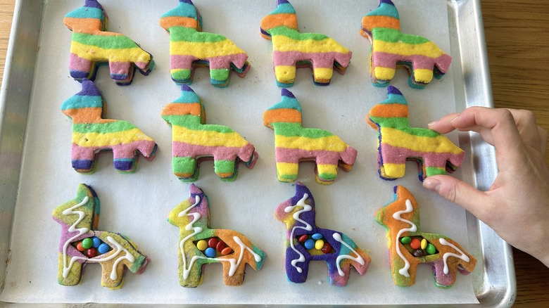 assembling piñata cookies on tray