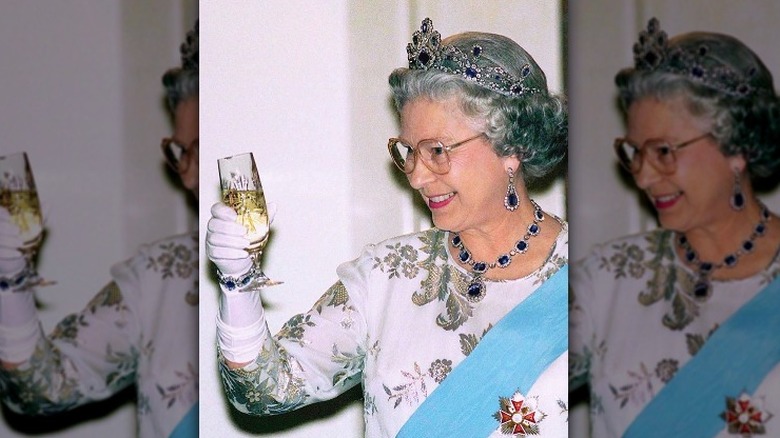 Queen Elizabeth toasting with Champagne