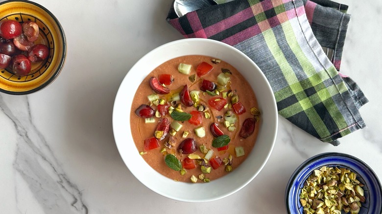 bowl of gazpacho with cherries and pistachios