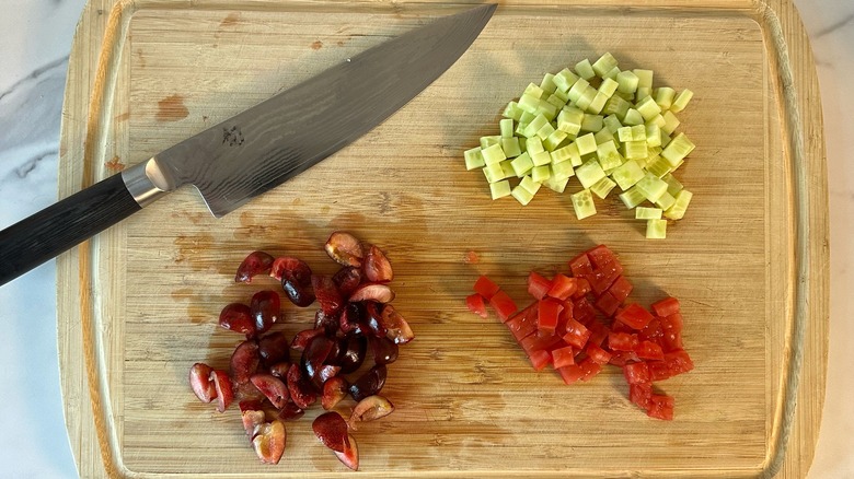 cherries, cucumbers, and tomatoes on cutting board