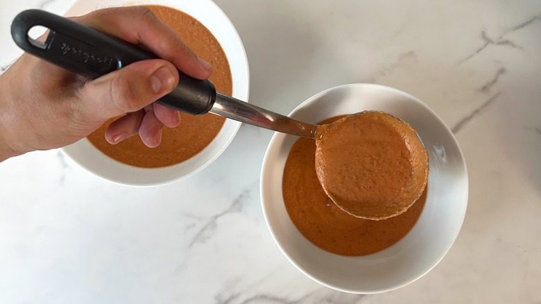 soup getting ladled into two bowls