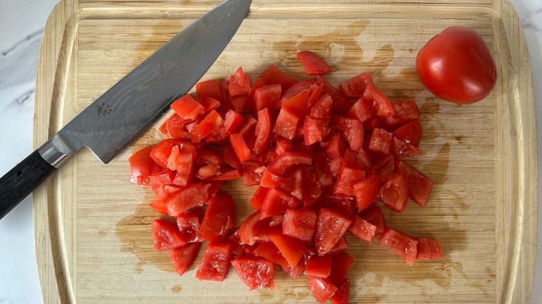 chopped tomatoes on cutting board