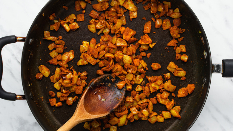 onion and spices in pan