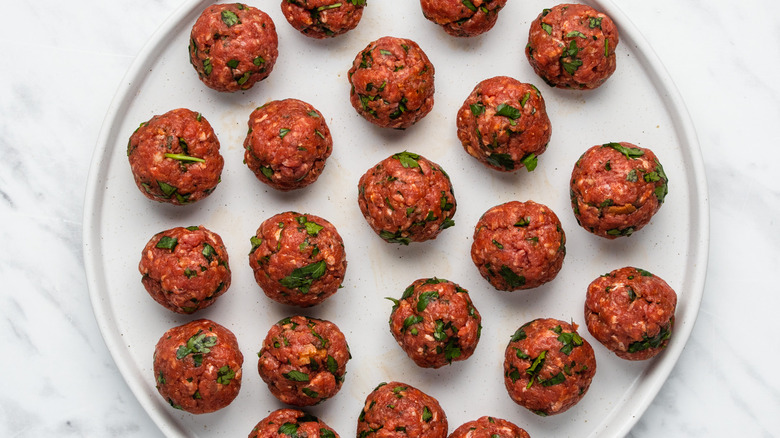 uncooked meatballs on plate