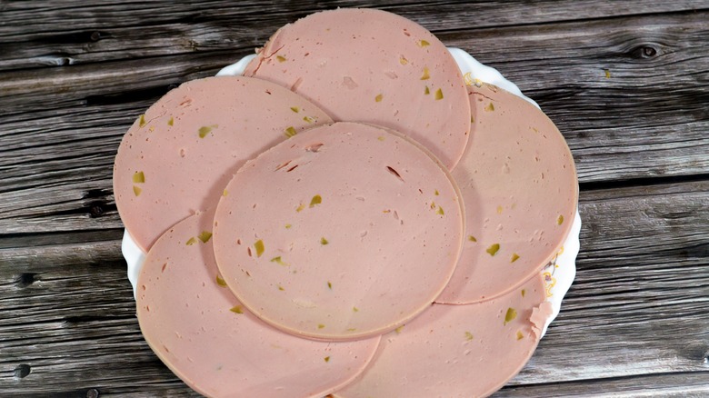 Top-view of sliced olive loaf on a white plate