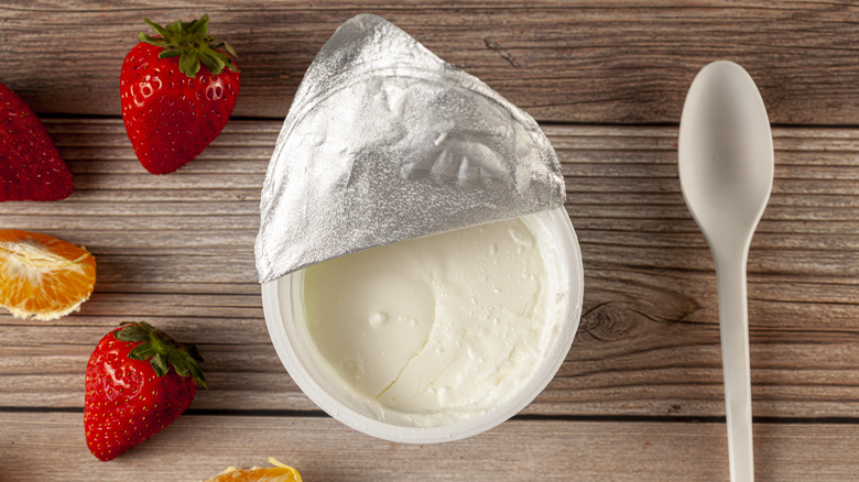 Greek yogurt cup with spoon on table 