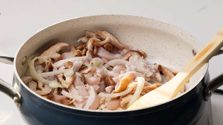 stir frying chicken and vegetables 