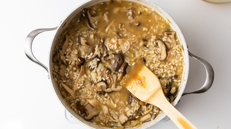 Mushroom risotto cooking in stock 