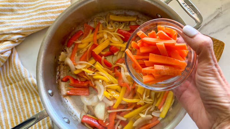 adding carrots to the pan