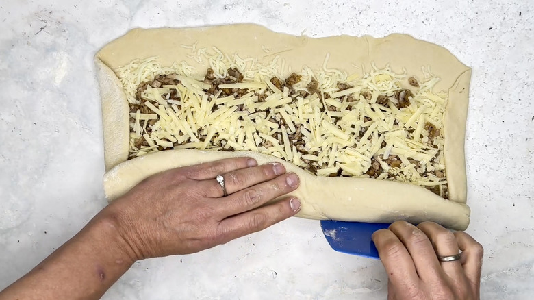 hand rolling uncooked stromboli