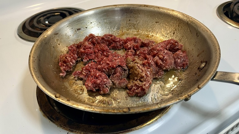 raw beef in skillet