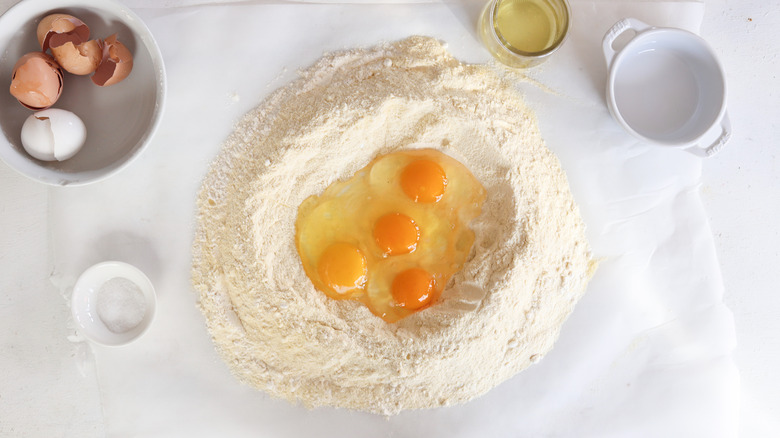 eggs cracked in well of flour