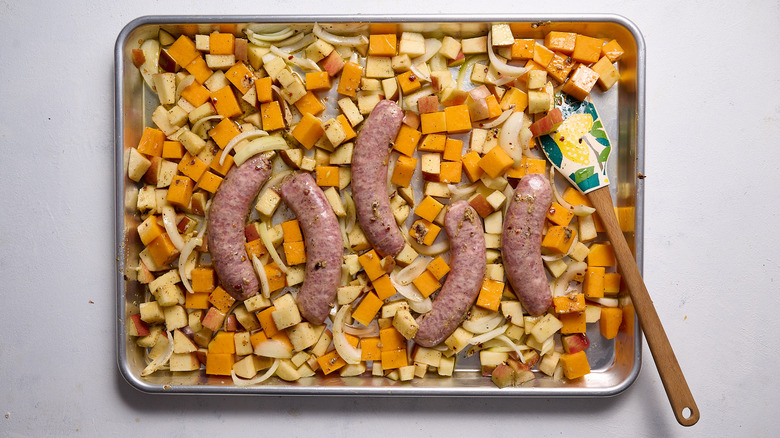 tossing vegetables on sheet tray