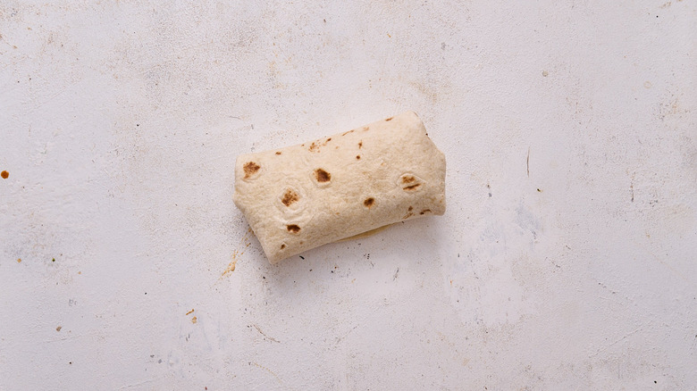 wrapped tortilla on table