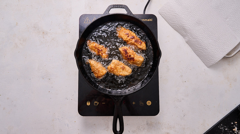 frying chicken in skillet