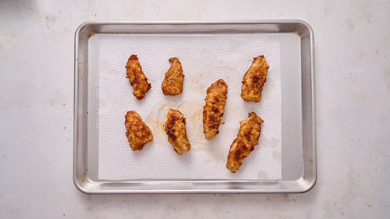 draining chicken on paper towel